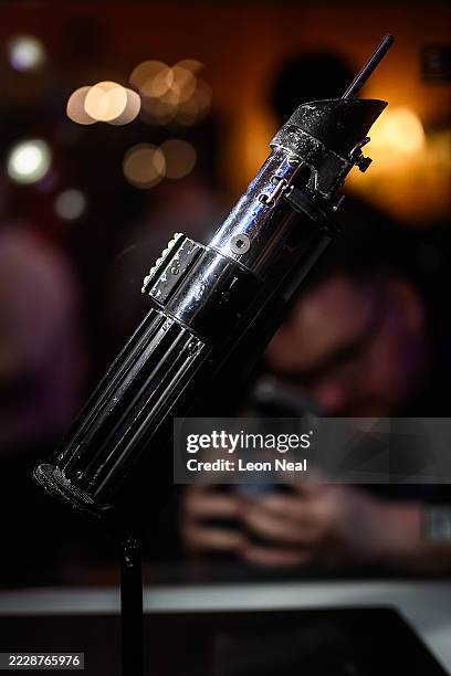 The screen-matched lightsaber prop, used by the character "Darth Vader" in the Star Wars films "The Empire Strikes Back and "Return Of The Jedi", is...