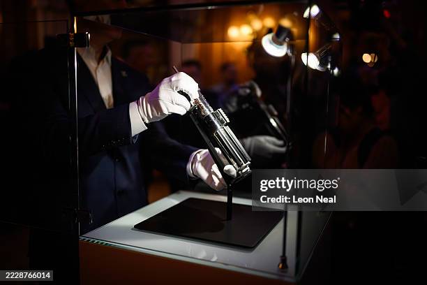 The screen-matched lightsaber prop, used by the character "Darth Vader" in the Star Wars films "The Empire Strikes Back and "Return Of The Jedi", is...