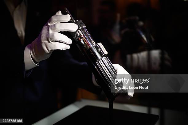 The screen-matched lightsaber prop, used by the character "Darth Vader" in the Star Wars films "The Empire Strikes Back and "Return Of The Jedi", is...