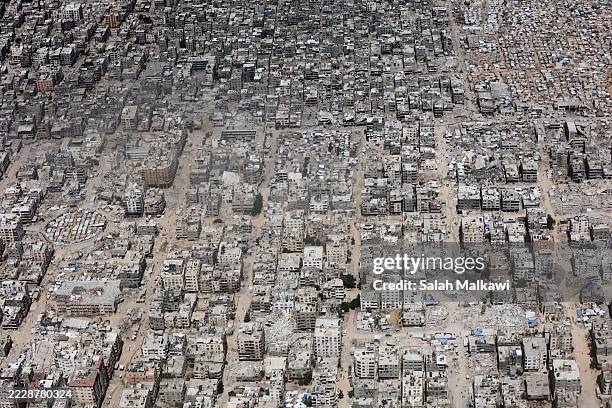 View from the air as Jordanian air force personnel in a Jordanian C-130 military aircraft perform an air drop of aid and humanitarian supplies on...