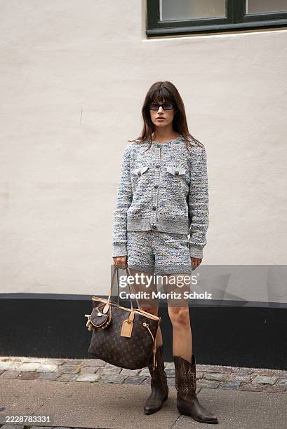 Lea Naumann, attending the Rave Review show during Copenhagen Fashion Week SS26, is seen wearing a textured grey and blue speckled boucle knit twin...