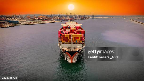 aerial front view container cargo ship at terminal commercial port. - öltanker stock-fotos und bilder