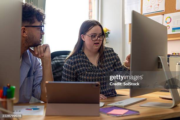 working together to finish a project - disability computer stock pictures, royalty-free photos & images
