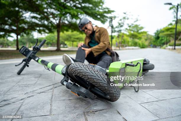 E-scooter rider injured on the road — leg and pain visible