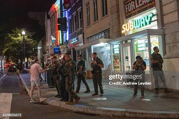 Man, who was later arrested, interacts with Border Patrol and FBI agents along the U Street corridor on August 10 in Washington, DC. U.S. President...