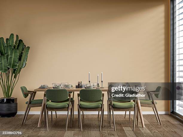 a modern but retro dining room with a full (set) table and chairs, a potted plant near a window, '70s retro style furniture - renovation of upholstered furniture stock pictures, royalty-free photos & images
