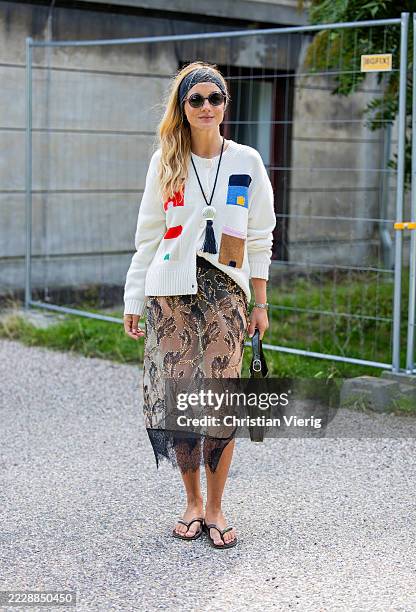 Mafalda Patricio wears cardigan, transparent skirt, Gucci green bag, head band, sunglasses outside Munthe during Copenhagen Fashion Week day three on...