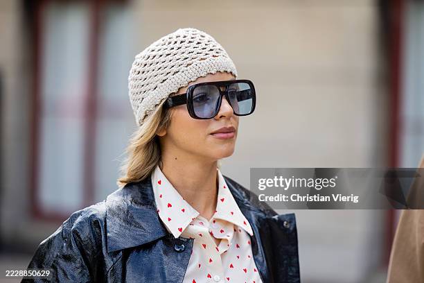 Guest wears crocheted white head piece outside Munthe during Copenhagen Fashion Week day three on August 06, 2025 in Copenhagen, Denmark.