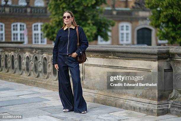 Guest wears a dark denim jacket with a beige corduroy collar and a front zipper closure. The jacket features buttoned cuffs and two front pockets....