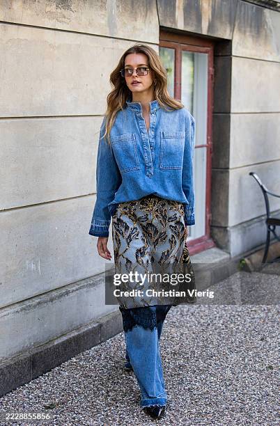 Guest wears transparent skirt, denim jeans outside Munthe during Copenhagen Fashion Week day three on August 06, 2025 in Copenhagen, Denmark.