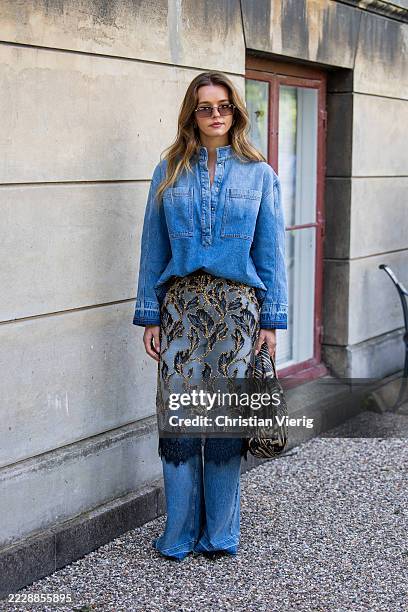 Guest wears transparent skirt, denim jeans outside Munthe during Copenhagen Fashion Week day three on August 06, 2025 in Copenhagen, Denmark.