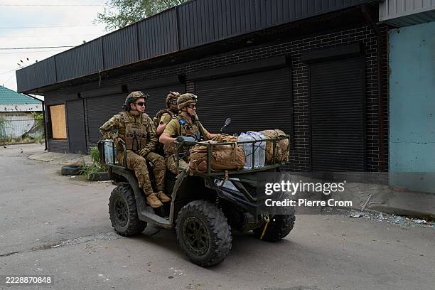 Soldiers of the Armed Forces of Ukraine, defending their land against invading Russian troops, ride on a quad on August 11, 2025 in Kostyantynivka,...