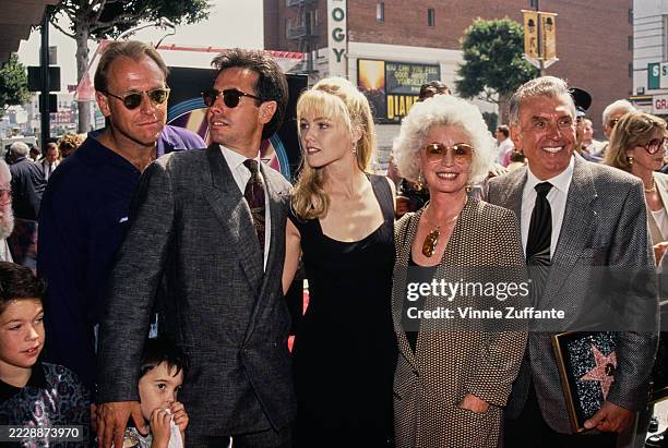 American actress Jennie Garth, wearing a black dress, Dennis James' wife, Micki, who wears a blazer over a scoop neck outfit, and American media...