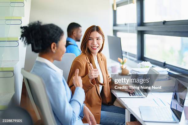 group of business professional engaged in a collaborative discussion in a modern office setting. concept of teamwork, business, and office communication. - performance review stock pictures, royalty-free photos & images