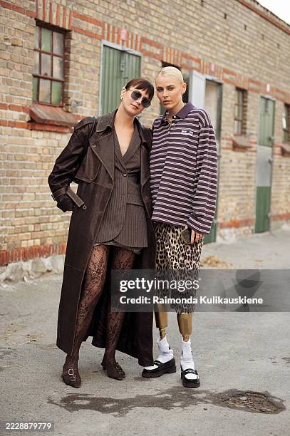 Guest wears brown blazes, denim mini skirt, brown leather coat and lace tights and Lauren Wasser wears leopard animal print shorts, brown and white...