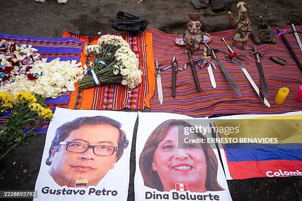 Shamans display images of Colombia's President Gustavo Petro and Peru's President Dina Boluarte during a ritual calling for an end to global...