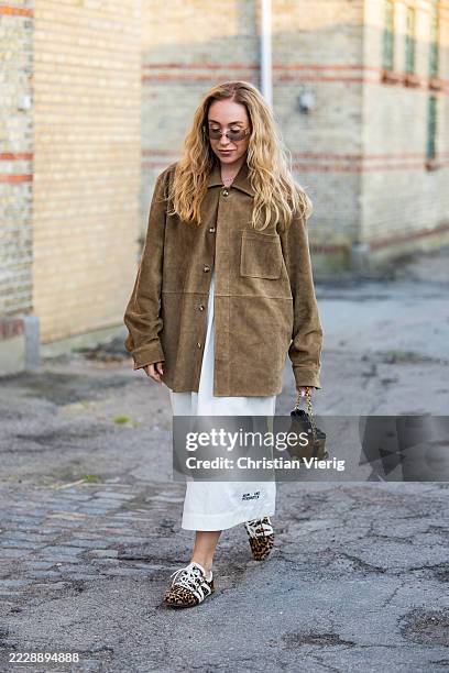 Sonia Lyson wears brown suede jacket, white skirt outside Baum & Pferdgarten during Copenhagen Fashion Week day three on August 06, 2025 in...