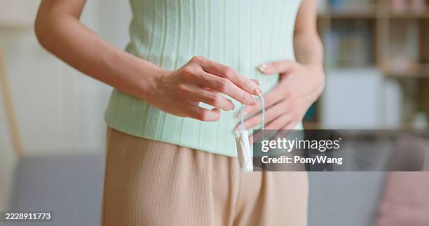asian woman menstrual pain at home - tampon stock pictures, royalty-free photos & images