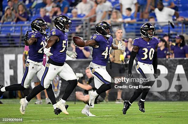 Jay Higgins IV of the Baltimore Ravens celebrates with teammates after making an interception in the fourth quarter against the Indianapolis Colts...