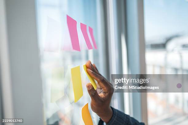 business brainstorming using sticky notes in a modern office setting - transfer window stock pictures, royalty-free photos & images