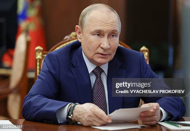 In this pool photograph distributed by Russian state agency Sputnik, Russia's President Vladimir Putin looks on as he holds a meeting on economic...