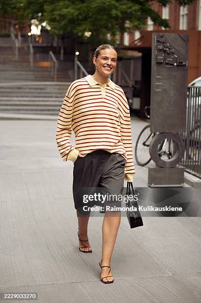 Emma Stallmark wears grey shorts, yellow and red stripped long sleeve top and black bag outside Deadwood during Copenhagen Fashion Week day four on...