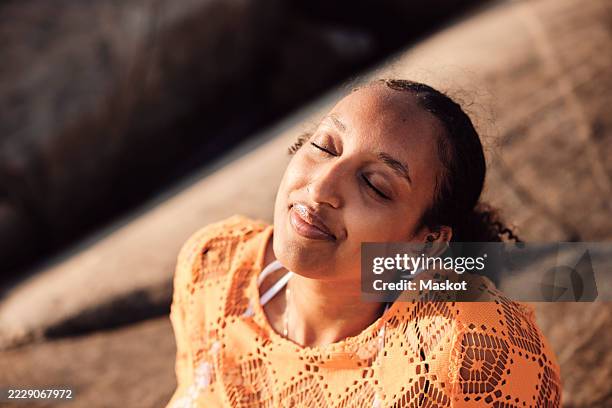 high angle view of carefree woman with eyes closed on sunny day - western europe stock pictures, royalty-free photos & images