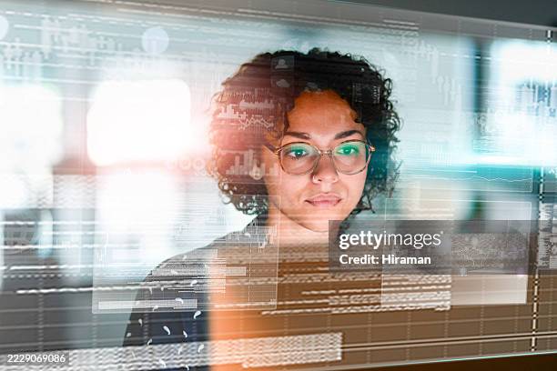 focused professional analyzing data displayed on a transparent digital interface - data science stock pictures, royalty-free photos & images
