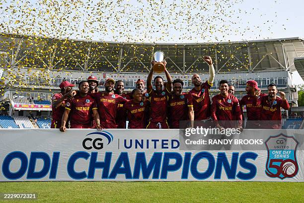 West Indies team celebrate with the trophy after winning the third and final One Day International cricket match between West Indies and Pakistan at...