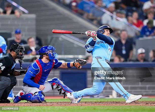 Daulton Varsho of the Toronto Blue Jays hits a home run against the Chicago Cubs during the eighth inning in their MLB game at the Rogers Centre on...