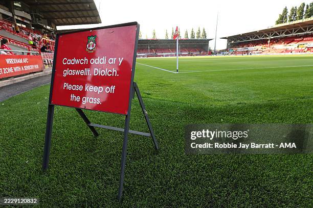 General interior view of Racecourse Ground as a sign is seen pitch side in Welsh and English saying 'Please Keep off the Grass' during the Carabao...