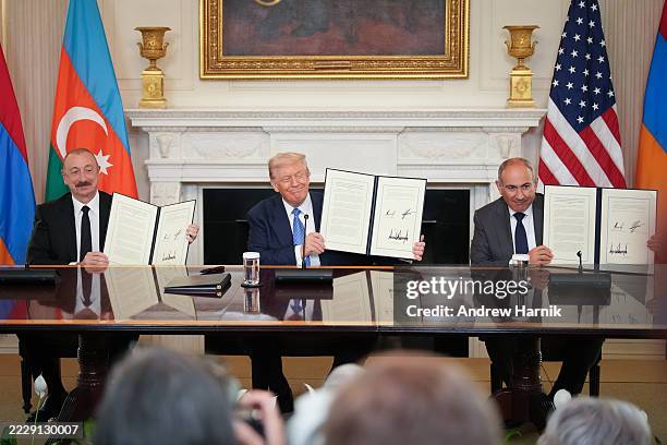 President Donald Trump , Azerbaijani President Ilham Aliyev , and Armenian Prime Minister Nikol Pashinyan hold up an agreement signed during a...