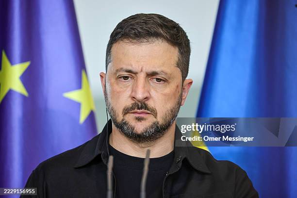 Ukrainian President Volodymyr Zelensky listens as German Chancellor Friedrich Merz speaks during a joint press conference at the Chancellery...