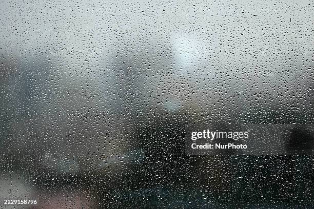 Raindrops splatter on a window pane as Nepal receives rainfall after a brief pause of precipitation on August 13, 2025.