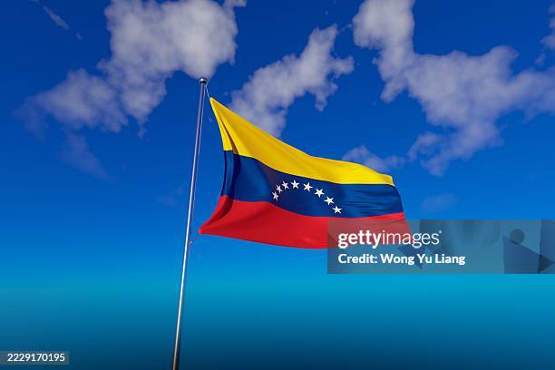 venezuela flag with blue sky background - venezuela imagens e fotografias de stock