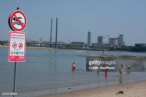 Sign indicating that swimming is banned is installed at Rhine beach in Duesseldorf, Germany, on August 13 as several fatal swimming accidents occur...