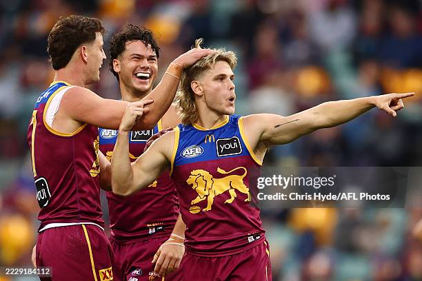 Will Ashcroft of the Lions celebrates a goal by team mate Logan Morris during the round 22 AFL match between Brisbane Lions and Sydney Swans at The...