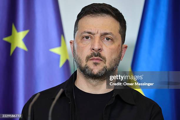Ukrainian President Volodymyr Zelensky listens as German Chancellor Friedrich Merz speaks during a joint press conference at the Chancellery...
