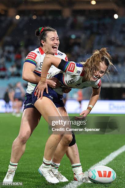 Tyra Wetere of the Warriors celebrates scoring a try with Tysha Ikenasio of the Warriors during the round six NRLW match between Canterbury Bulldogs...