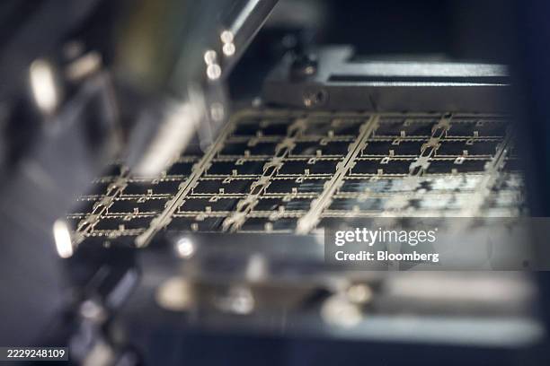 Semiconductor dies inside an engraving machine at a Hana Microelectronics Pcl factory in Bang Pa-In, Ayutthaya Province, Thailand, on Wednesday, Aug....