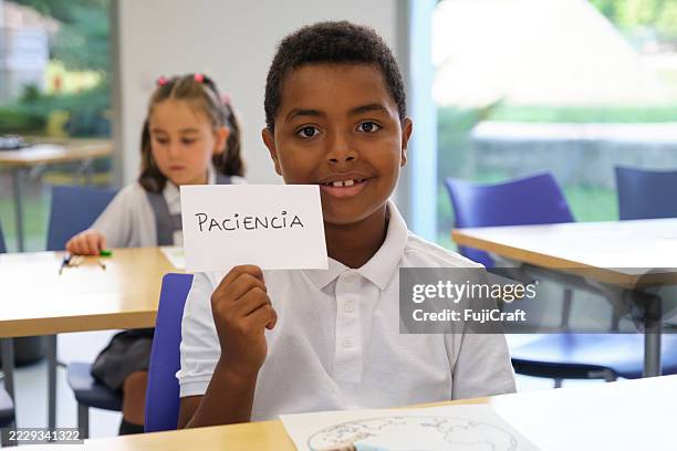 elementary student learning spanish word paciencia in classroom - learning spanish stock pictures, royalty-free photos & images