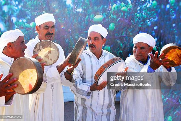 berber musicians planying bendir-tambourine. - moroccan culture stock pictures, royalty-free photos & images