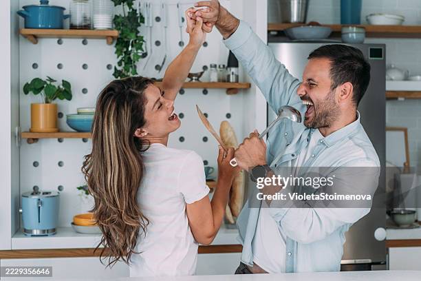 fun in the kitchen. - flirting stock pictures, royalty-free photos & images