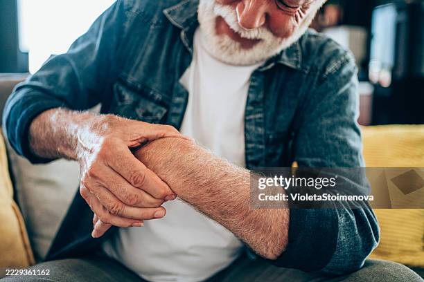 senior man massage his hand with wrist pain - wrist stock pictures, royalty-free photos & images