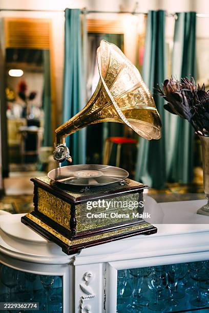 decorative vintage gramophone placed on elegant white showpiece furniture - gramophone stock pictures, royalty-free photos & images