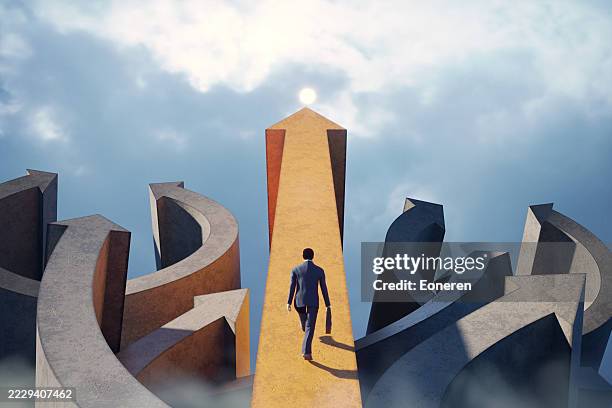 businessman walking on straight arrow path towards success - conclusão imagens e fotografias de stock