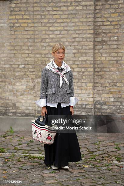 Inês Isaías, attending the Skall Studio show during Copenhagen Fashion Week SS26, is seen wearing a cropped grey herringbone tweed jacket with front...