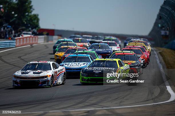 Shane Van Gisbergen, driver of the WeatherTech Chevrolet, and Ryan Blaney, driver of the Menards/Richmond Water Heaters Ford, race during the NASCAR...