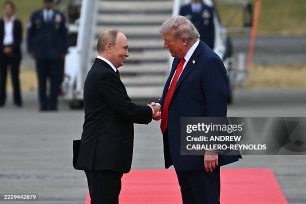 President Donald Trump greets Russian President Vladimir Putin on the tarmac after they arrived at Joint Base Elmendorf-Richardson in Anchorage,...