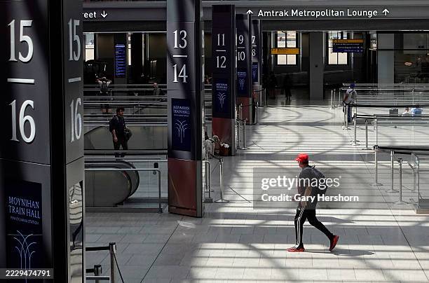 People walk through the Moynihan Train Hall at Penn Station on August 9 in New York City.